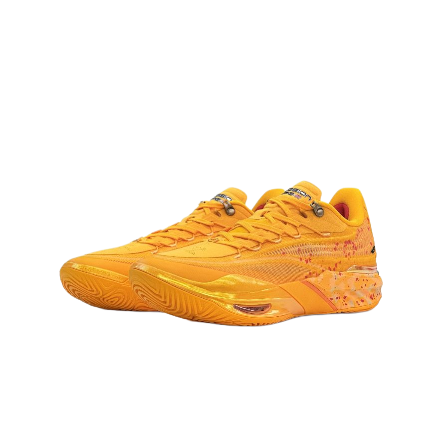 Unisex low-top basketball sneaker in yellow with lace-up front and side splatter accents