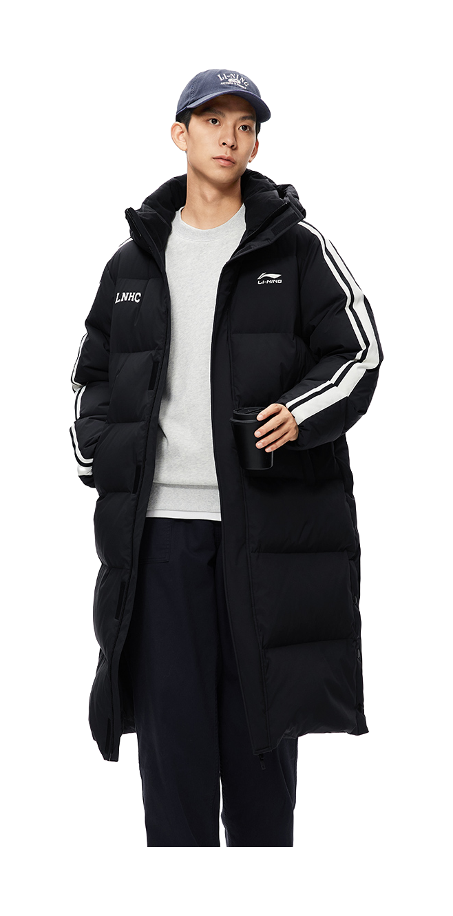 Men's black long down jacket with hood and side stripe panels, worn over a tee