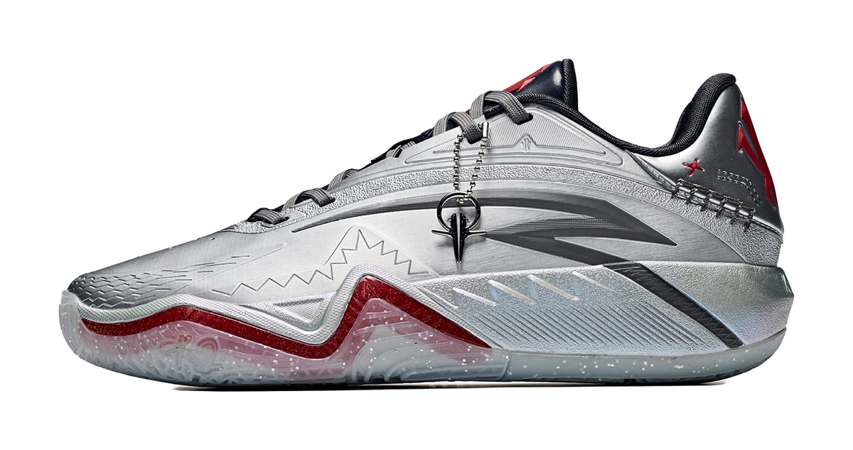Low basketball shoe in silver-gray with black collar and crimson/red accents, lace-up