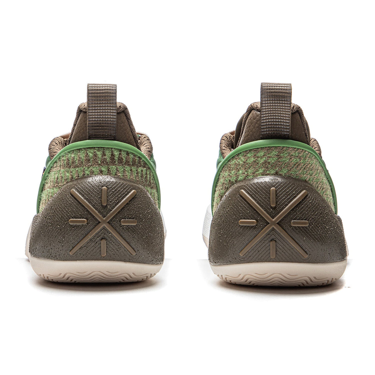 Men's basketball shoe heel view with brown traction pods and green trim on white sole