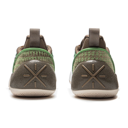 Men's basketball shoe heel view with brown traction pods and green trim on white sole