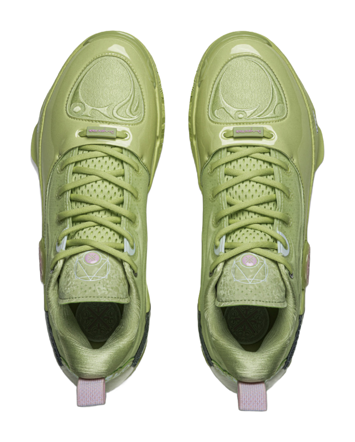 Pair of green basketball shoes front view with lace rows and cushioned tongue
