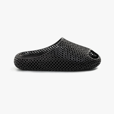 Black 3D-printed slip-on slippers with textured honeycomb upper and oval side cutout