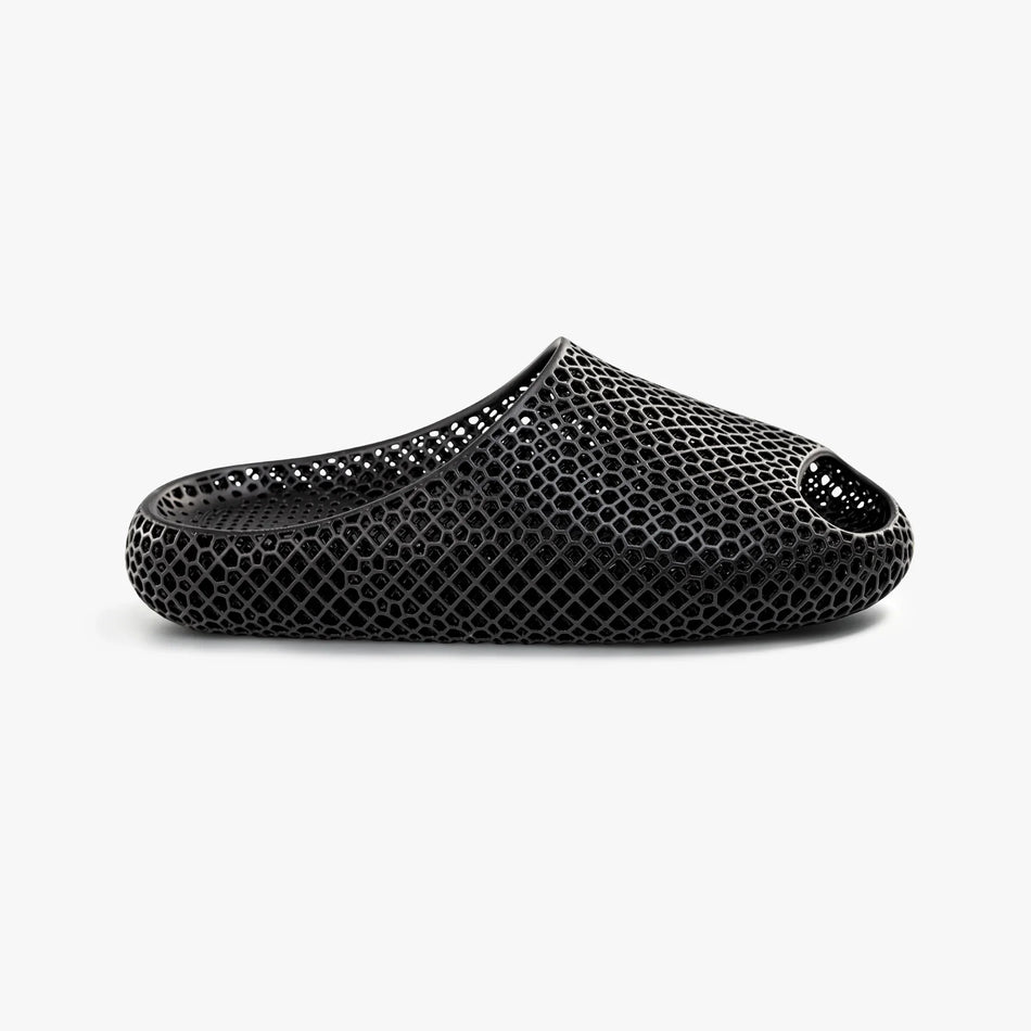 Black 3D-printed slip-on slippers with textured honeycomb upper and oval side cutout