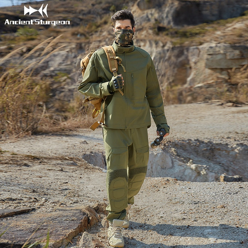 Green tactical jacket on model with high collar, zip front, and utility pockets