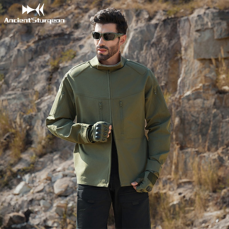Green tactical jacket with zip front and high collar, modeled with sunglasses
