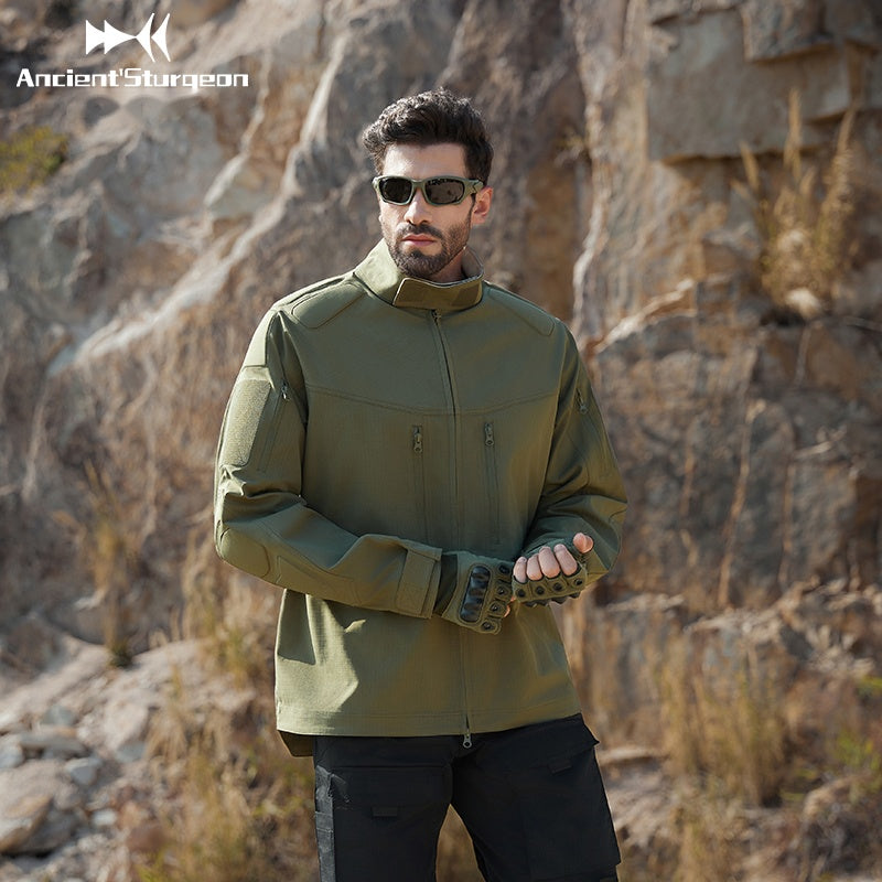 Green tactical jacket front view with high collar and zip, hands gesturing