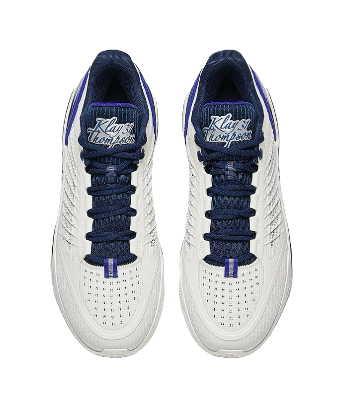Pair of unisex low basketball shoes with navy laces and white mesh quarter