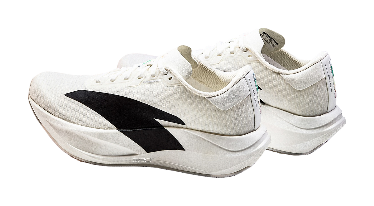 Women’s low-top running shoes, white with black logo accents, lace-up style and padded collar