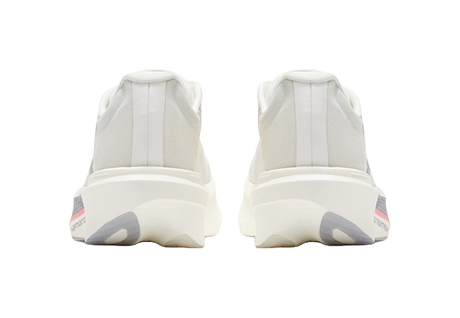 Back view of low running shoes, white knit uppers with heel tabs and cushioned sole.