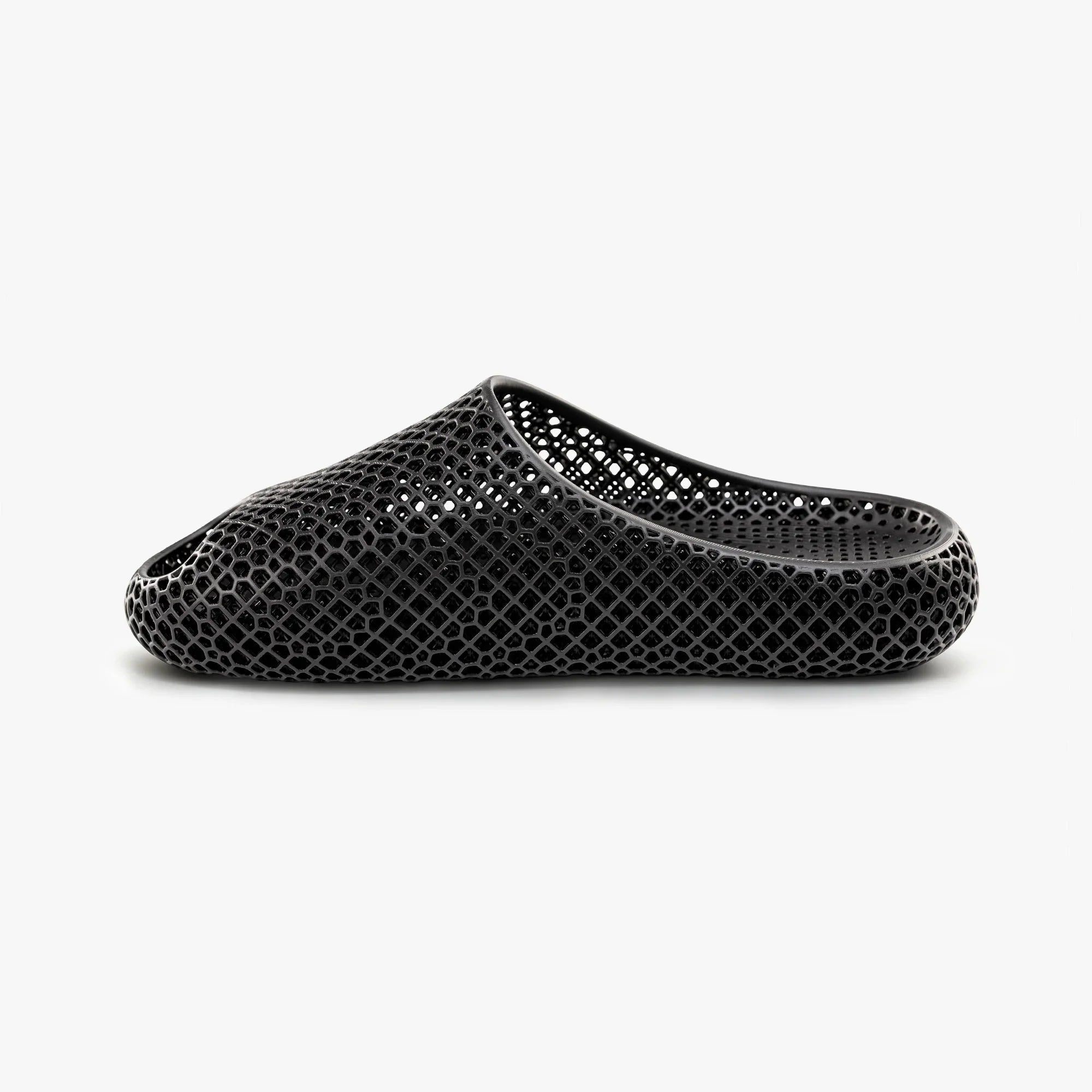 Black 3D-printed slip-on slippers with textured honeycomb upper and curved side opening