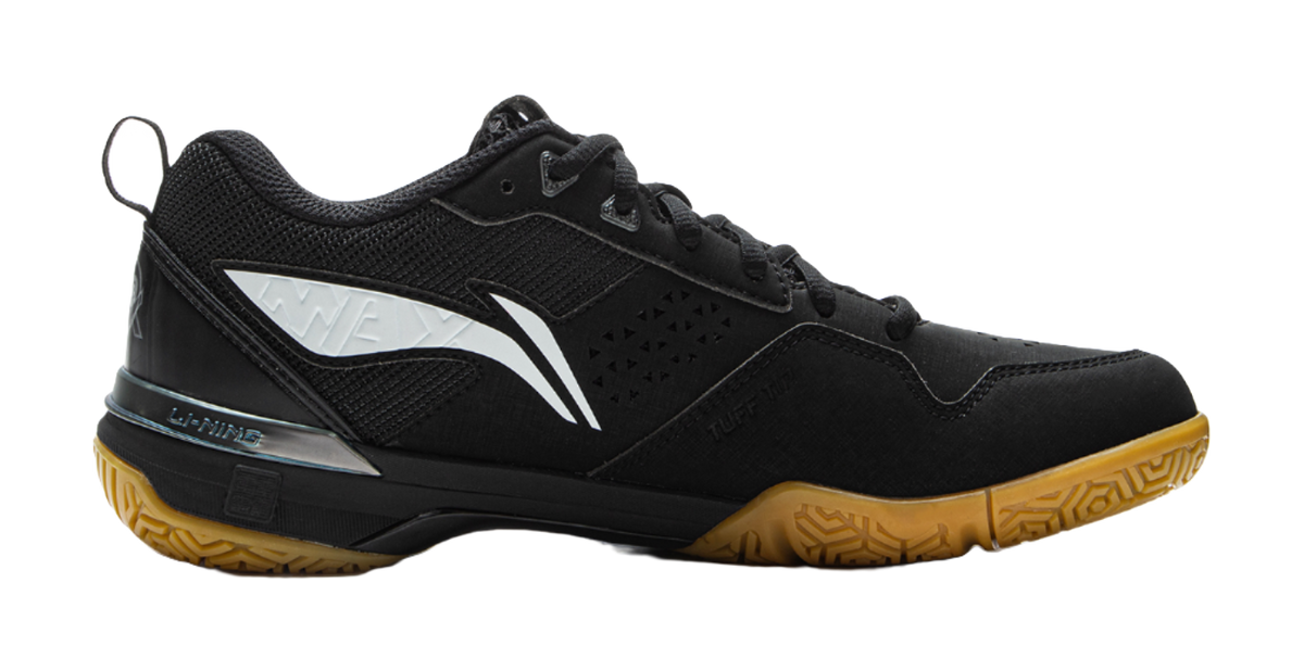 Black badminton shoe side view with white W-shaped stripe and patterned quarter panel.