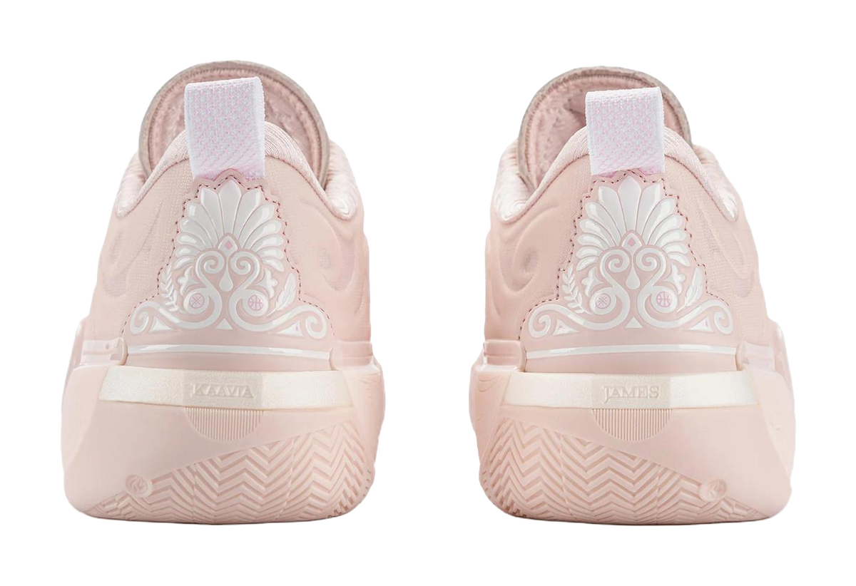 Pair of light pink basketball shoes from back with heel branding and pull tab