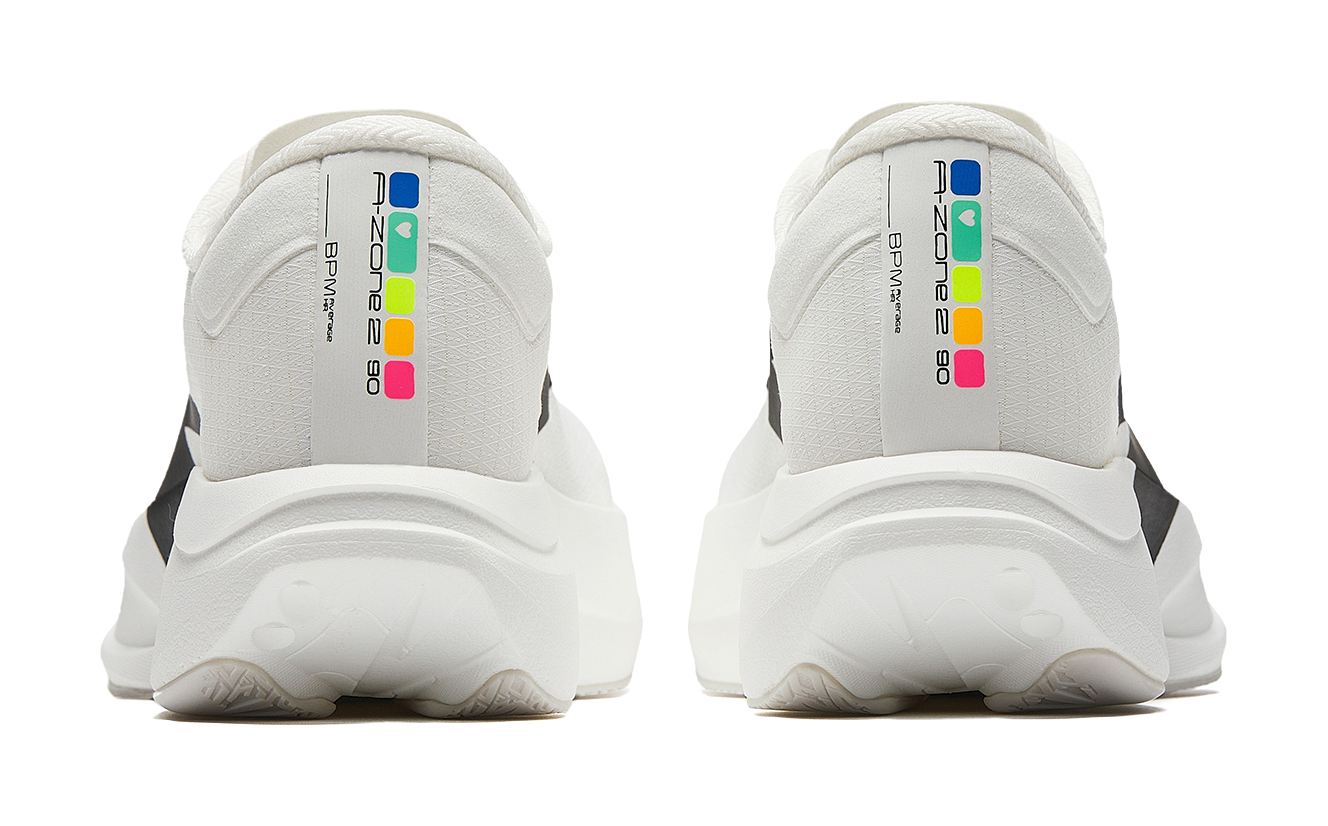 Pair of white running shoes with back heel tabs and colorful logo labels.