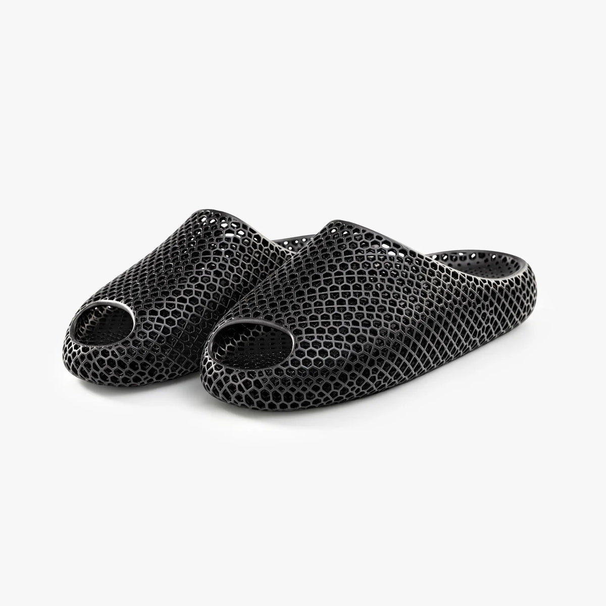 Black 3D-printed slip-on slippers, pair view, textured honeycomb upper and open toe