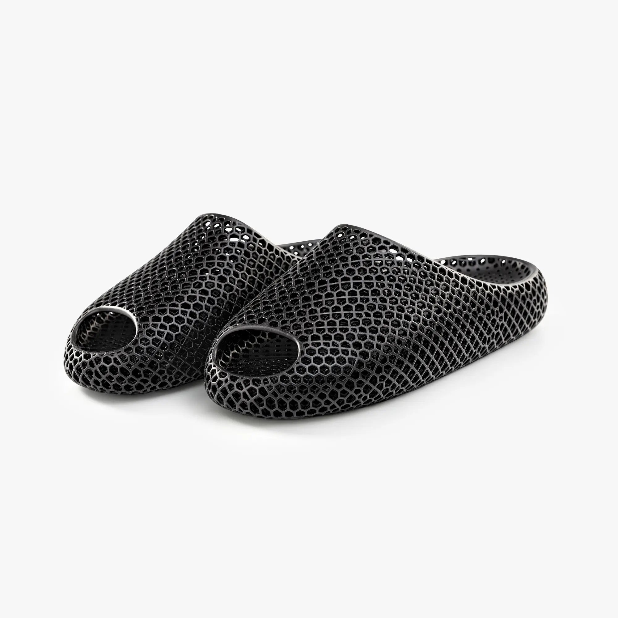 Black 3D-printed slip-on slippers, pair view, textured honeycomb upper and open toe
