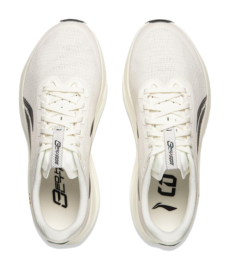 Champagne white running shoe pair with lace-up front and black heel logo