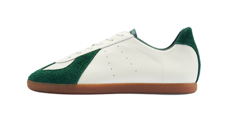 Low-top training shoes with white leather upper and green side panel, gum sole