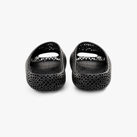Black 3D-printed slip-on slippers, rear view, glossy textured honeycomb and heel cutouts