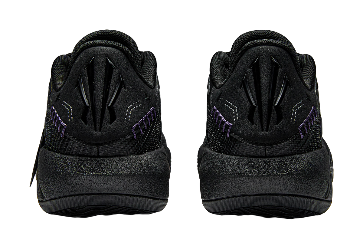 Pair of black basketball shoes with padded heel, lace-up front, purple side detail