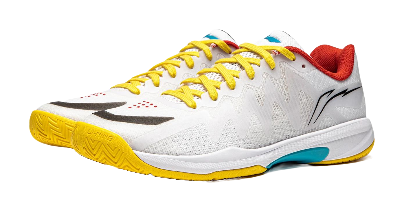 White table tennis shoe with yellow laces and yellow outsole, black logo and red collar