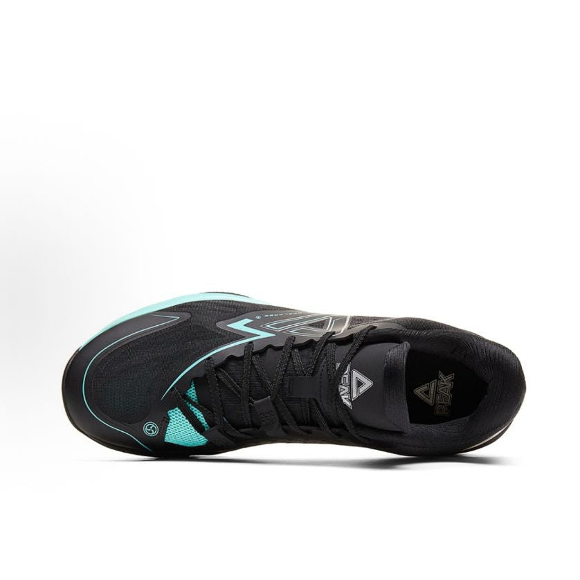 Black basketball shoe with teal piping, lace-up upper, and side branding details