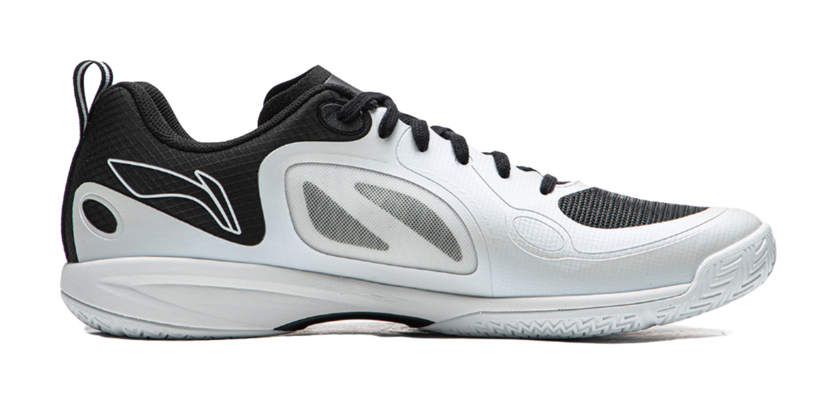 Table tennis shoe in white with black panels, lace-up front, and curved sole