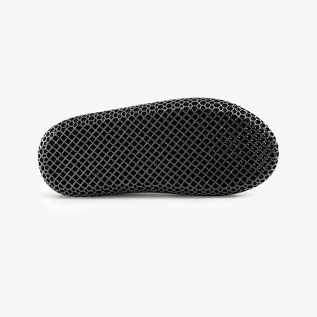 Black 3D-printed slip-on slipper with textured honeycomb upper and rounded toe