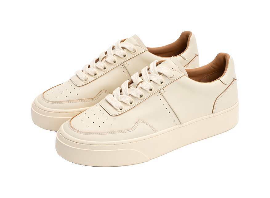 Pair of antique white low-top skate shoes with lace-up style and thick cupsole