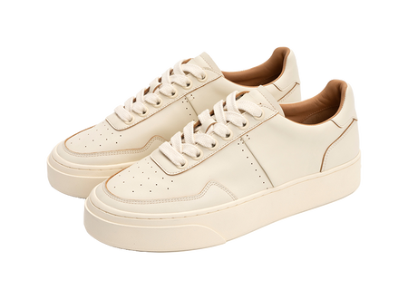 Pair of antique white low-top skate shoes with lace-up style and thick cupsole