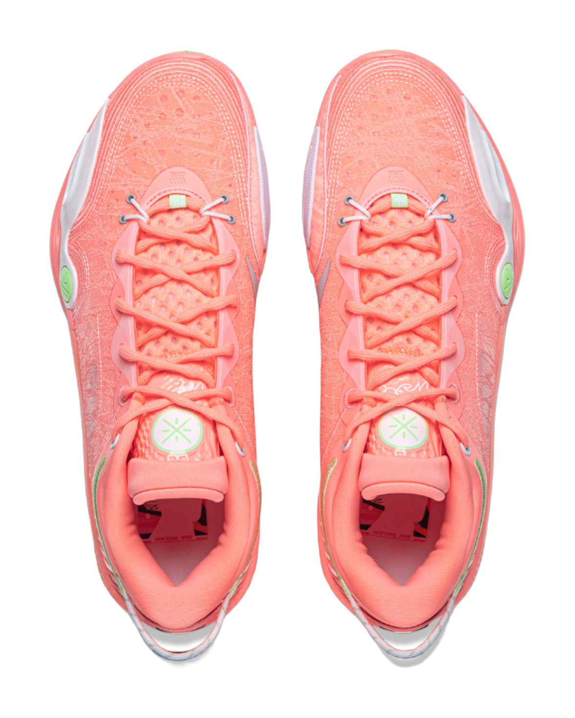 Pair of men's low-top basketball shoes, pink-orange uppers with laces and green heel marks