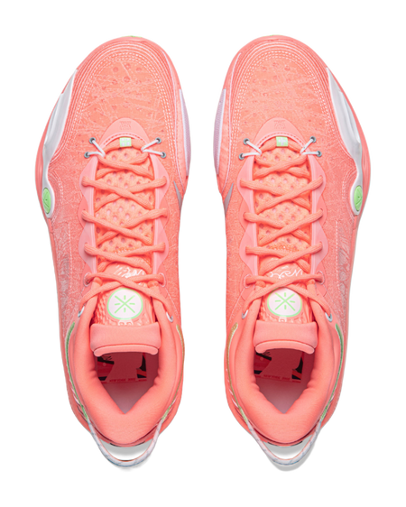 Pair of men's low-top basketball shoes, pink-orange uppers with laces and green heel marks
