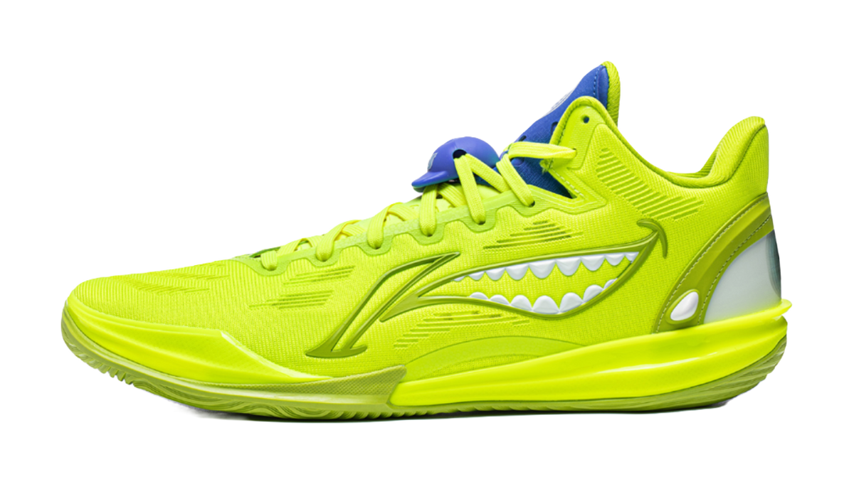 Green low basketball shoe with lace-up closure and monster-tooth side graphic