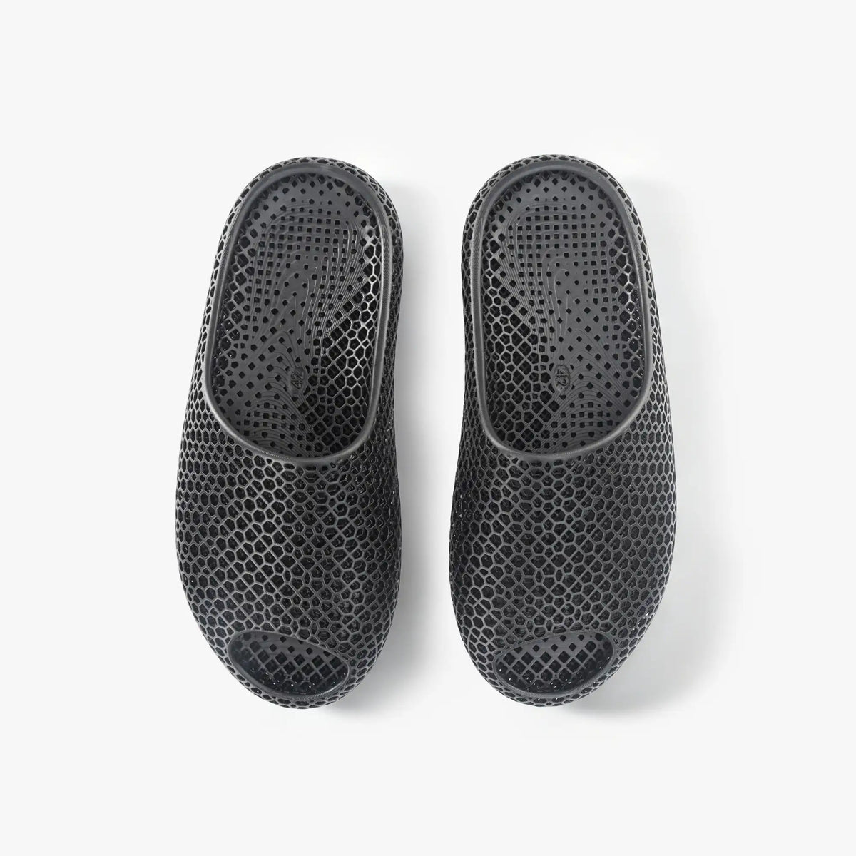 Black 3D-printed slip-on slippers, back view, textured honeycomb upper with heel opening