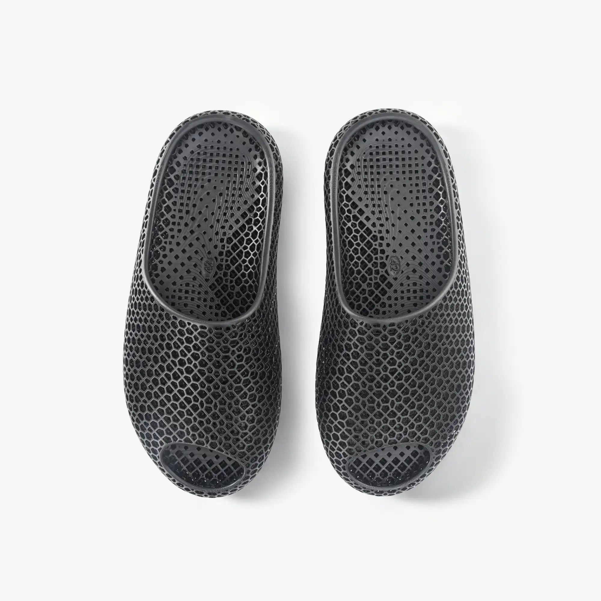 Black 3D-printed slip-on slippers, back view, textured honeycomb upper with heel opening