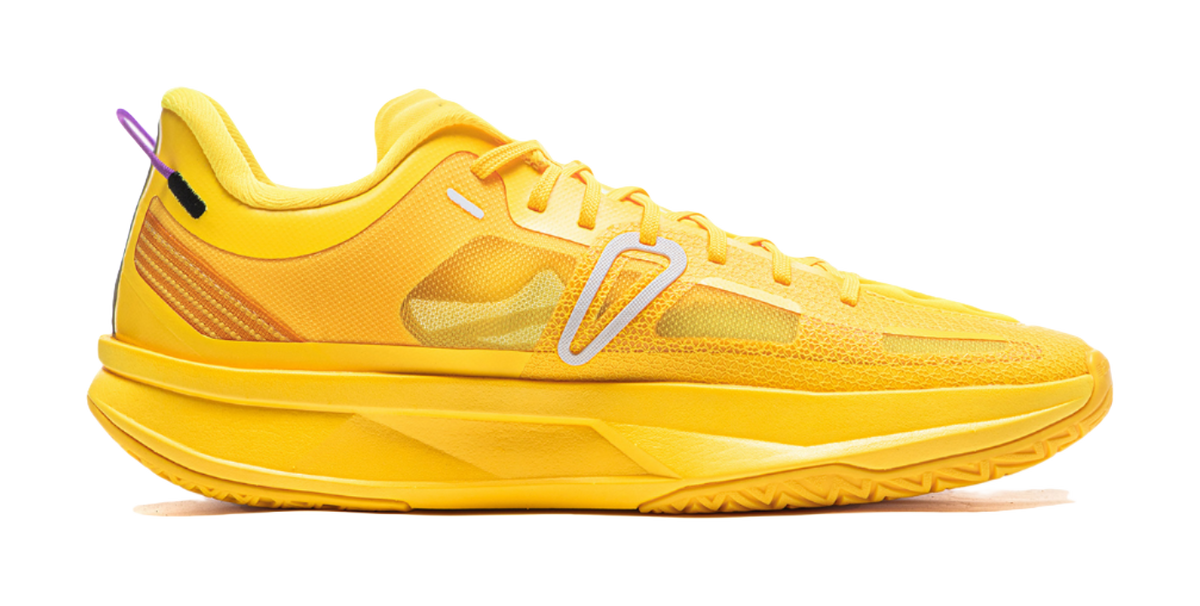 Yellow basketball shoe with textured upper, white stripes, and lace-up front