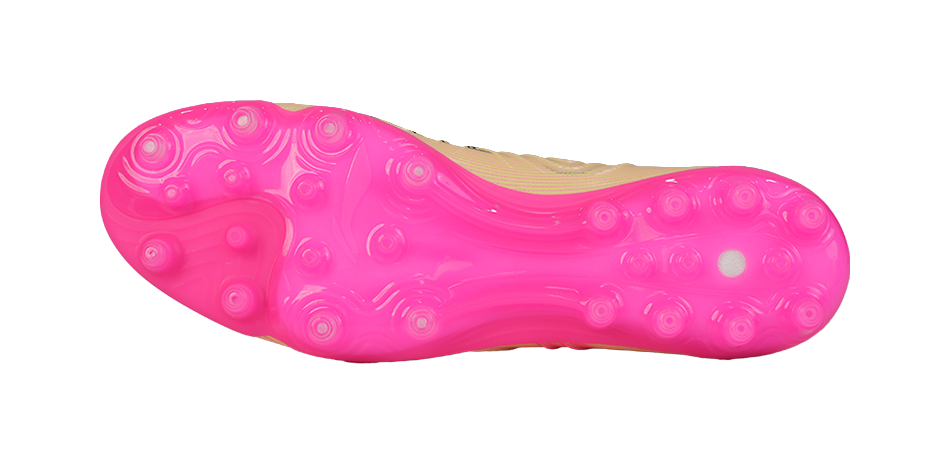 Pink rubber soccer cleat outsole with round turf studs and traction pattern