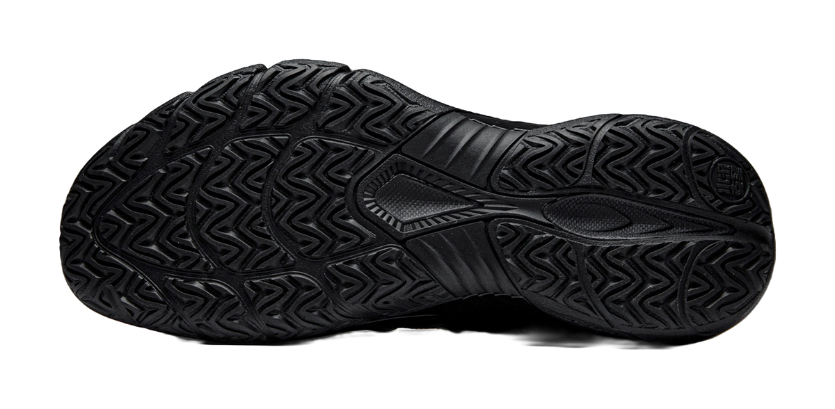 Black low-top basketball shoe outsole with textured traction tread