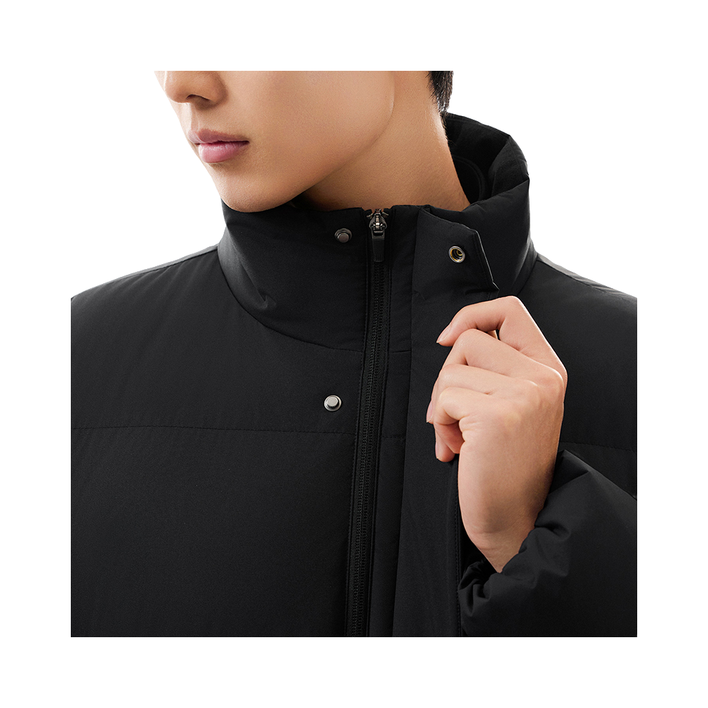 Black puffer down jacket close-up: stand collar, metal zipper, and snap buttons