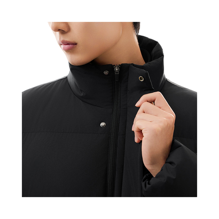 Black puffer down jacket close-up: stand collar, metal zipper, and snap buttons