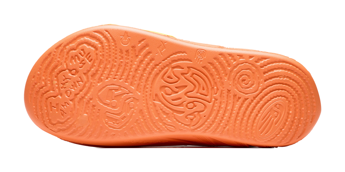 Orange slide slipper outsole with deep tread pattern and embossed logo text