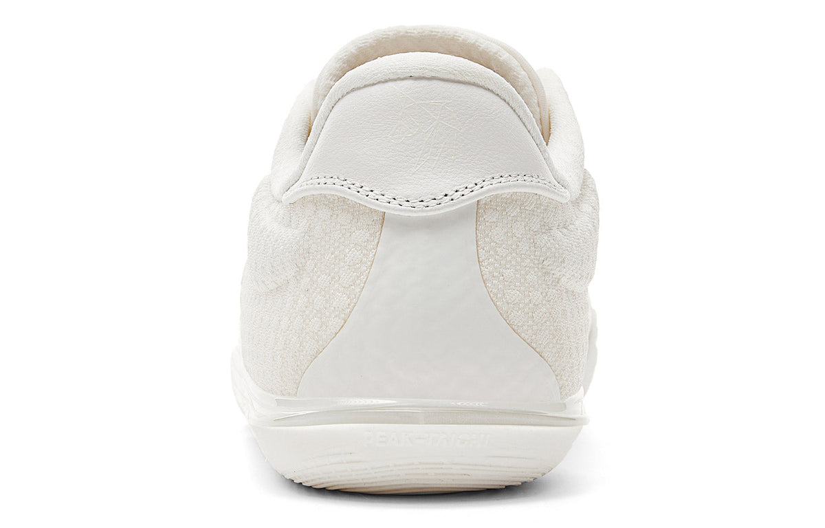 Milky white low-top basketball shoe rear view with padded heel and pull tab
