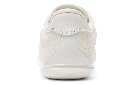 Milky white low-top basketball shoe rear view with padded heel and pull tab