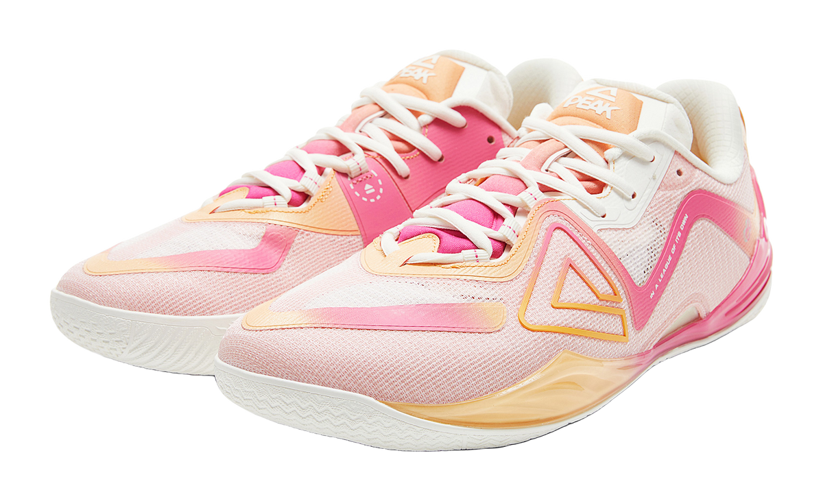 Pair of pink basketball shoes with white laces, orange highlights, low-profile sole