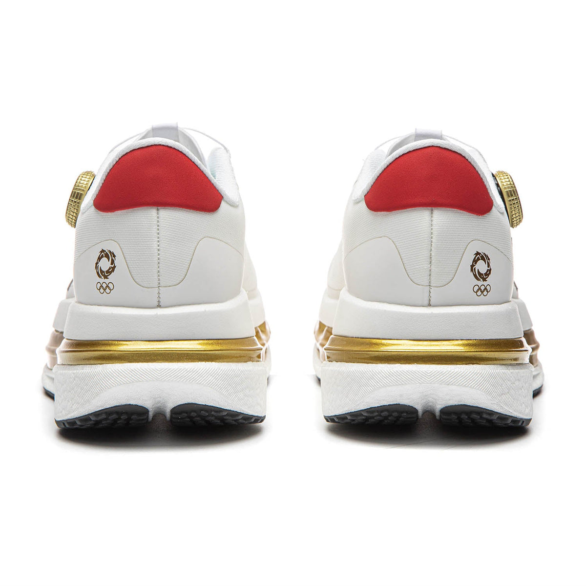 Pair of men's white running shoes, back view with red heel inserts and gold heel logos