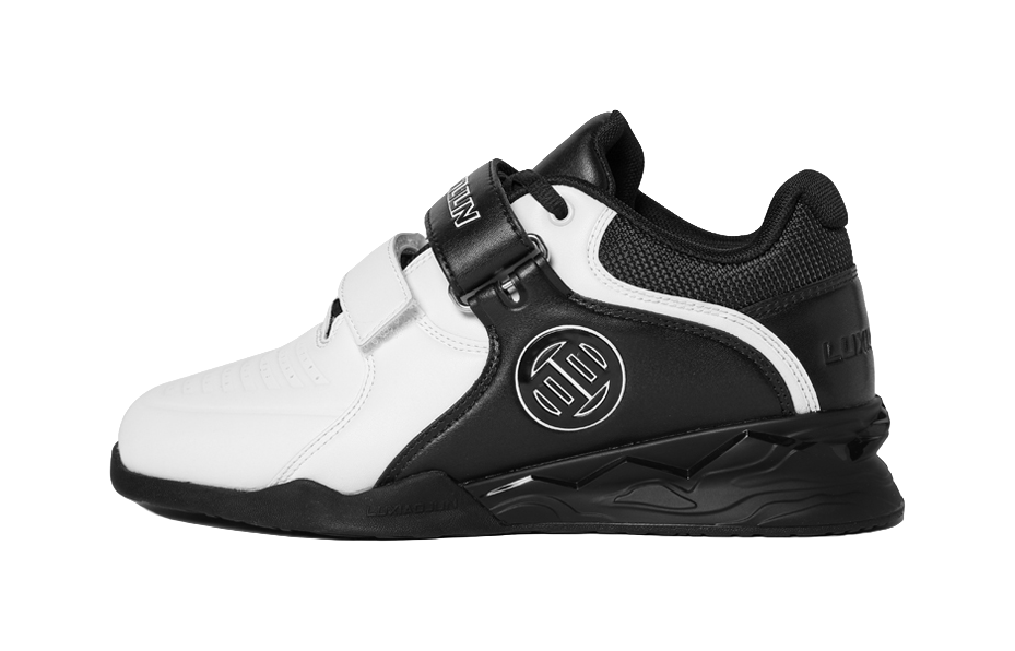White and black low-top training shoes with side stripe, hook-and-loop strap