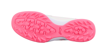 Pink rubber turf outsole with stud pattern, underside view of youth soccer shoe