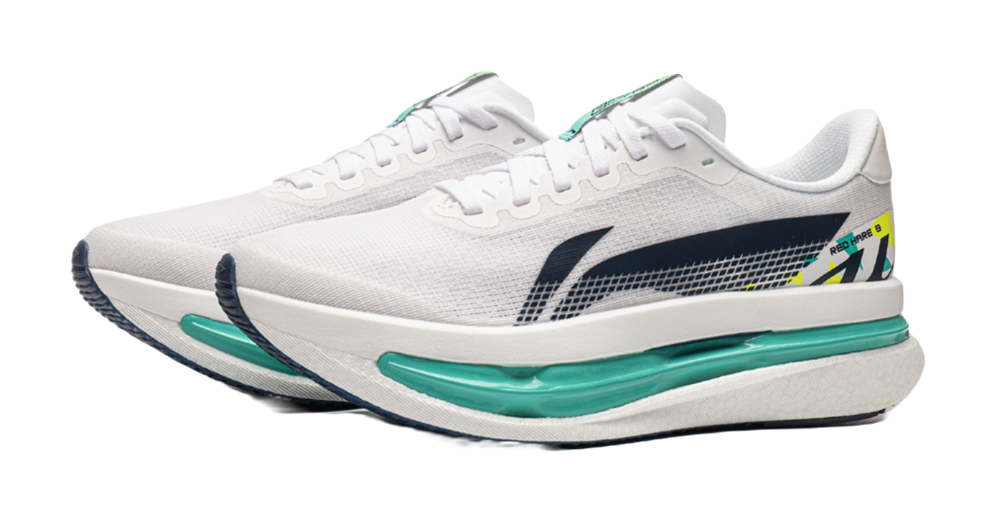 White knit running shoe with navy heel detail and teal midsole, side profile