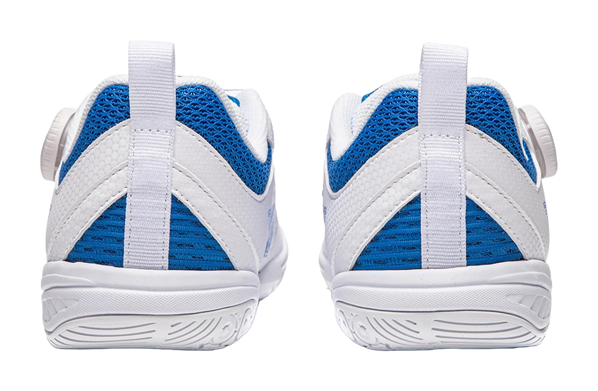White table tennis shoe heel view with blue mesh panels and ridged traction outsole.
