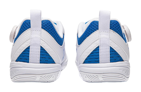 White table tennis shoe heel view with blue mesh panels and ridged traction outsole.